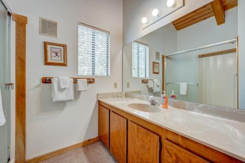 a bathroom with a sink and a large mirror at Beaver Pond Northstar Luxury Chalet with Hot Tub in Truckee
