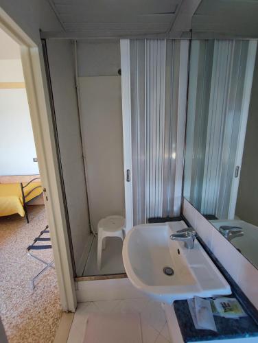 a bathroom with a glass shower and a sink at Hotel Primavera sul mare in Lido di Savio