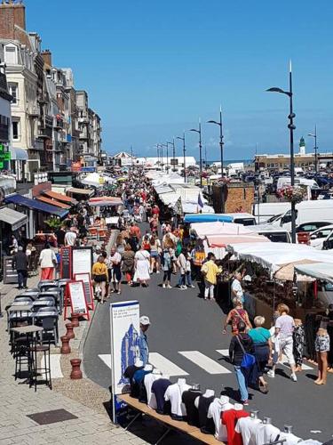 a crowd of people walking down a street in a market at Chez Elise et Vincent in Eu