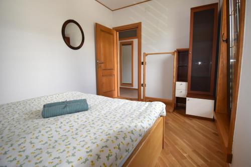 a bedroom with a bed and a mirror at Apartma Tima in Bovec