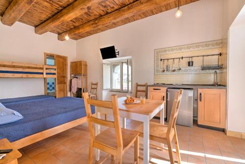 a kitchen and dining room with a table and chairs at Villa Vesuviana in Torre del Greco