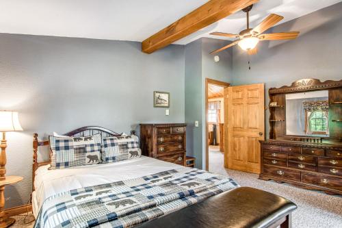 a bedroom with a bed and a ceiling fan at Red Arbor Retreat in Arbor Vitae