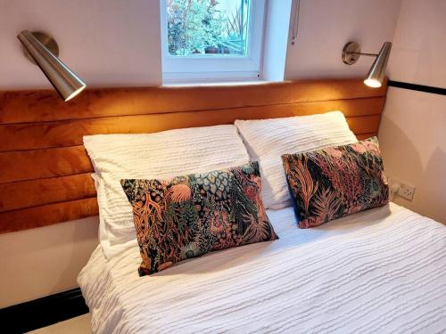 a bedroom with a bed with two pillows on it at Gorgeous 2 Bedroom Sanctuary in Kent
