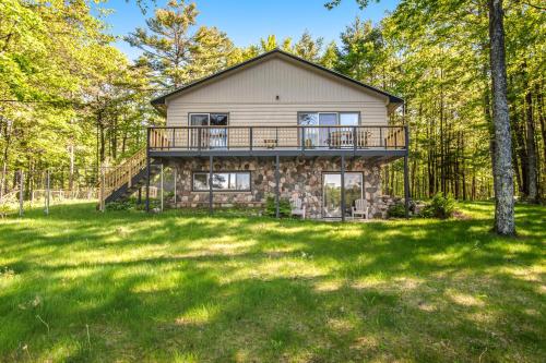 a home in the woods with a large yard at SILK Cabin in Manitowish Waters