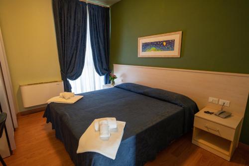 a hotel room with a bed and a window at Hotel Break House Ristorante in Terranuova Bracciolini