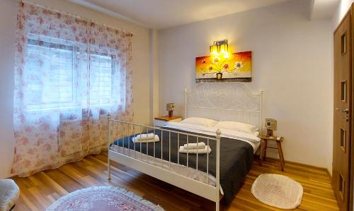 a bedroom with a bed and a window at Fancy 1BD Family Friendly in Historical Centre in Bucharest
