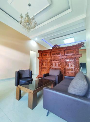 a living room with a couch and a table at Homestay Parikesit Rent Full House in Semarang