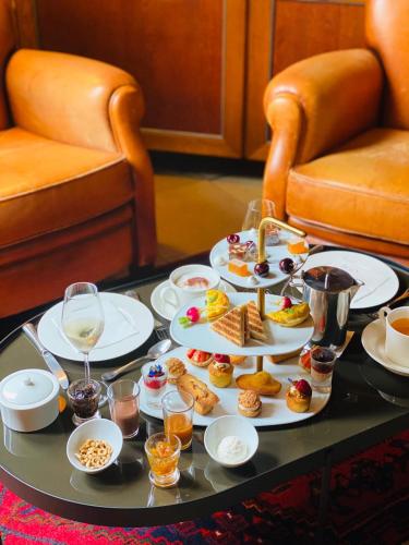 a tray of food on a table with plates of food at Cèdre Beaune, A Beauvallon Hotel & Spa in Beaune