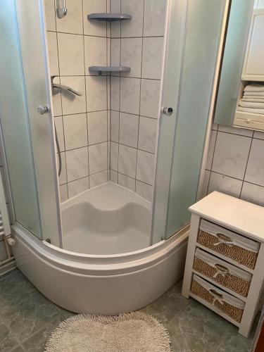 a bathroom with a shower with a tub at L&L in Pakoštane
