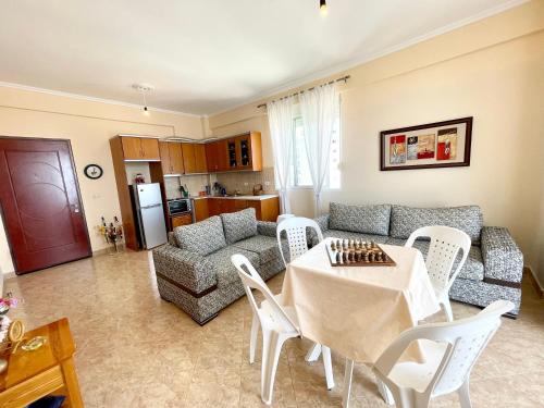 a living room with a table and a couch at Ernest Apartments in Sarandë