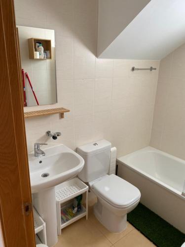 a bathroom with a toilet and a sink and a tub at Appartement N618 avec solarium sur golf resort in Alhama de Murcia