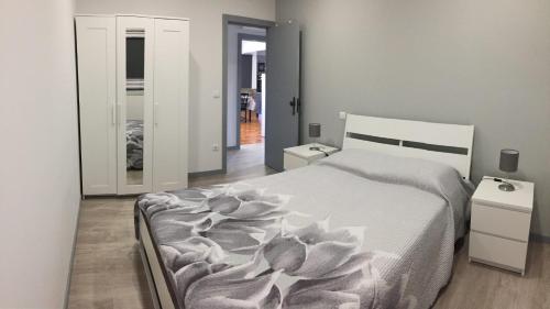 a bedroom with a bed with a flower on it at Apartamento Armães in Viana do Castelo
