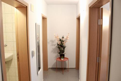 a bathroom with a vase of flowers on a table at SUNSET ART Beach Front in Chernomorets