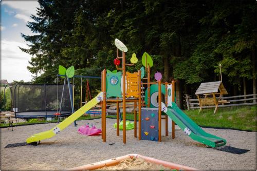 a playground with a slide and a slideintend at Zdrojowy Gościniec - domki Rabka-Zdrój in Rabka