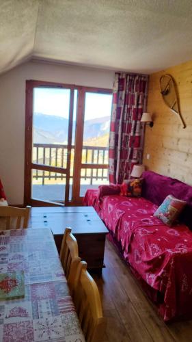 un salon avec un canapé et une table dans l'établissement Appartement cosy à Valmeinier avec vue montagne et piscine, à Valmeinier
