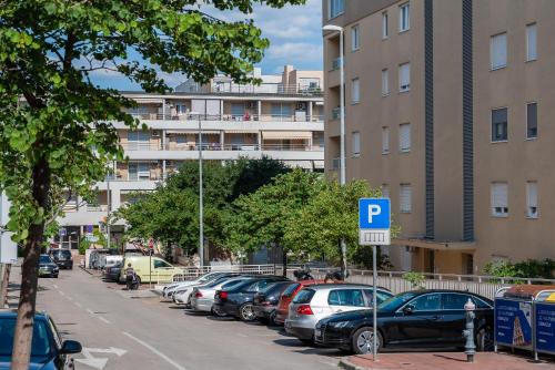 a parking lot with cars parked in front of buildings at Apartment SUNČICA in Split