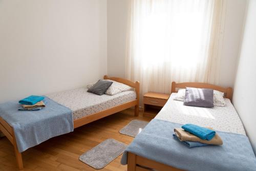 a bedroom with two beds and a window at Apartment SUNČICA in Split