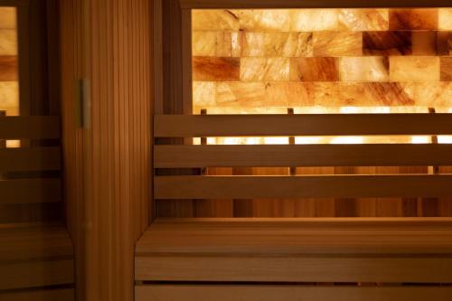 a wooden bench in a room with a stone wall at Loch Fyne Hotel & Spa in Inveraray