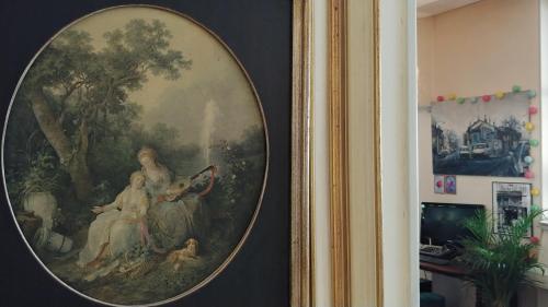a painting of a group of people on a wall at Hôtel Le Victoria in Draguignan