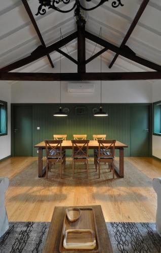 a dining room with a wooden table and chairs at Quinta do Santinho in Amarante