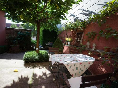 a table with plates on it in a garden at Gästehaus Stadtmitte in Merzig