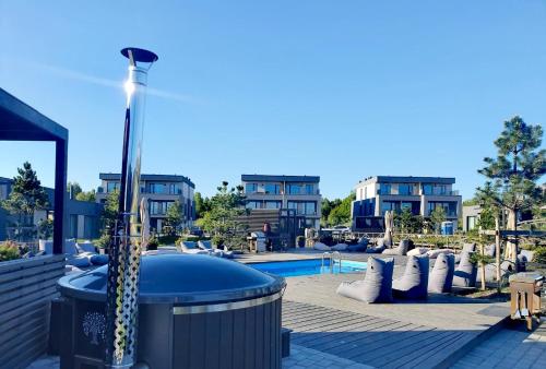 a pool with a hot tub in a resort at SUN HOME in Palanga