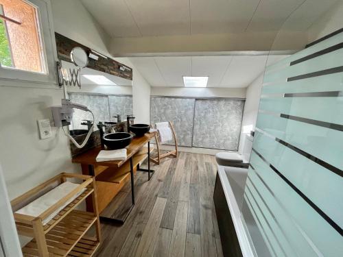 a bathroom with a sink and a counter with bowls at Auberge Val Moureze Hôtel & Spa in Mourèze