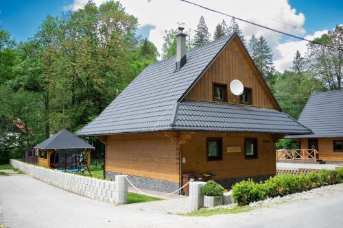 a large wooden house with a black roof at Chata Nezábudka in Oščadnica