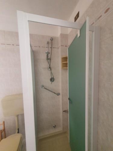 a bathroom with a shower with a glass door at Margi House in Bigolino