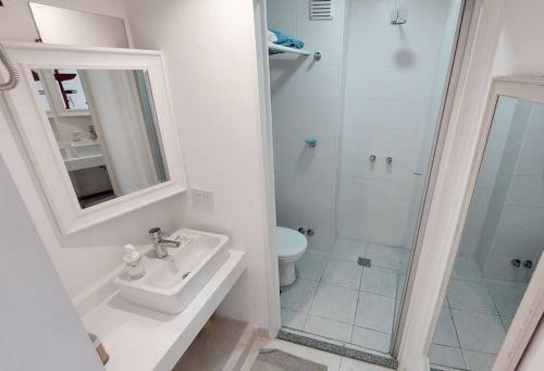 y baño blanco con lavabo y ducha. en Colombres 585 by depptö en Buenos Aires