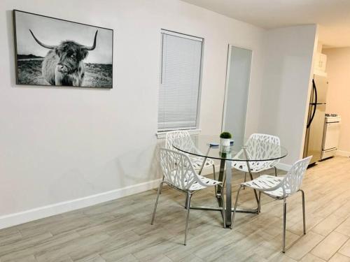 a dining room with a glass table and chairs at Mayfield @ Oyster Creek - Tranquil Creek & Nature! in Sugar Land