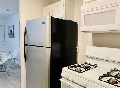 a kitchen with a white stove and a refrigerator at Mayfield @ Oyster Creek - Tranquil Creek & Nature! in Sugar Land