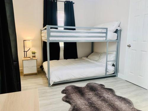 a bedroom with two bunk beds and a rug at Mayfield @ Oyster Creek - Tranquil Creek & Nature! in Sugar Land