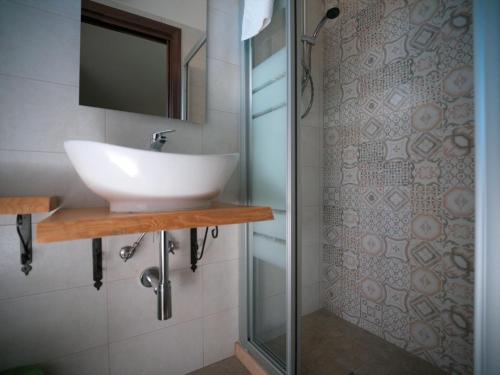 a bathroom with a sink and a shower at Villa Anté in Angri