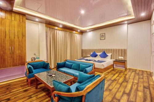 a hotel room with a bed and a table and chairs at Baan by Snow City Farm in Vashisht
