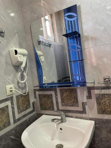 a bathroom with a sink and a mirror at Hotel Georgia in Gonio
