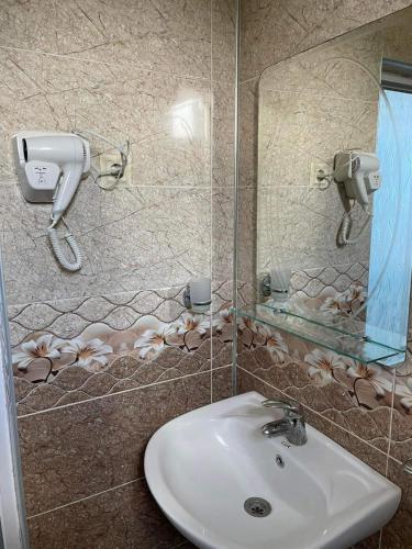 a bathroom with a sink and a mirror at Hotel Georgia in Gonio