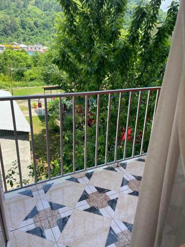 a balcony with a fence and a tile floor at Hotel Georgia in Gonio