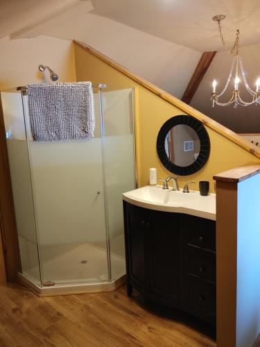 a bathroom with a shower and a sink at Stonewater Manor B&B in Gananoque