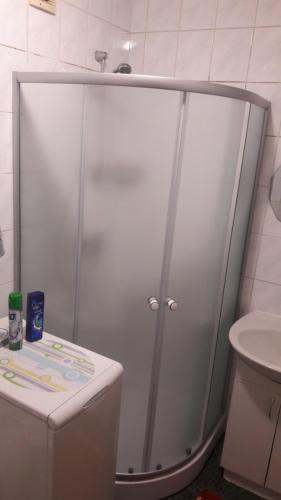 a shower stall in a bathroom with a sink at 1-комн в центре Днепра на Грушевского in Dnipro