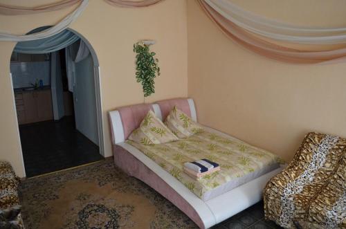 a living room with a couch and a chair at 1-комн в центре Днепра на Грушевского in Dnipro