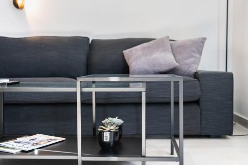 a living room with a couch and a table at 248 Boutique Studios, Sliema in Sliema