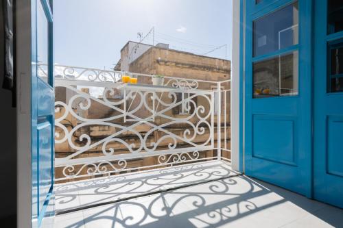 a balcony with a blue door and a view at 248 Boutique Studios, Sliema in Sliema