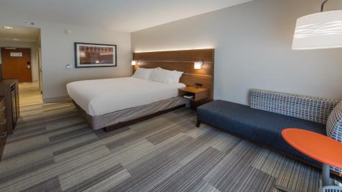 a hotel room with a bed and a couch at Holiday Inn Express Gatlinburg Downtown by IHG in Gatlinburg