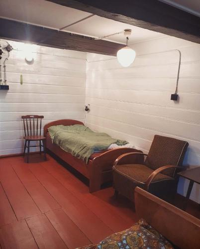 a room with a bed and a chair in it at Chata Josef in Rokytnice nad Jizerou