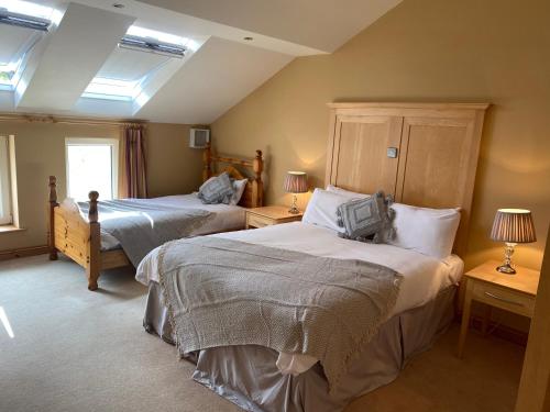 a bedroom with two beds and two lamps at Atlantic Lodge in Galway