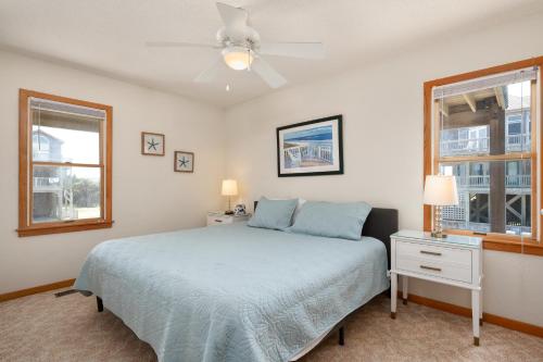 a bedroom with a bed and two windows at Siers Seashore in Waves