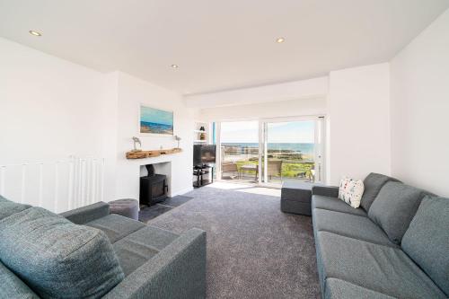 a living room with a couch and a fireplace at The Beach Boathouse in Carnoustie