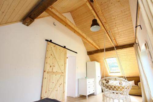 a barn door in a room with a bedroom at Dobre Miejsce in Międzyzdroje