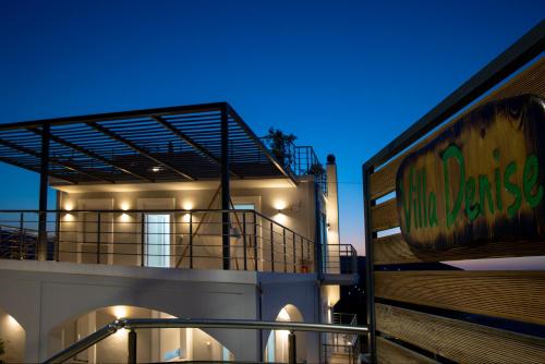a building with a sign on the side of it at Villa Denise in Kalyves